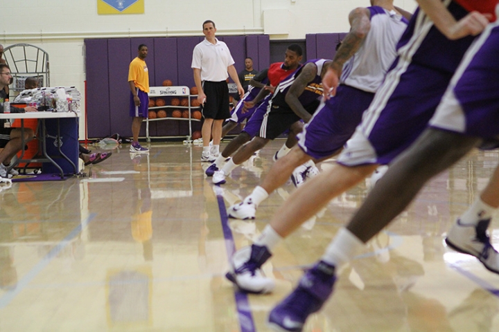 Lakers players make sure their feet hit the line while running suicide sprints.